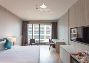 a hotel room with a bed and a desk at Laguna Grand Hotel & Spa Songkhla in Songkhla
