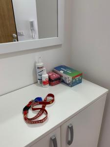 a white counter top with a red ribbon on it at Apartman A3 in Ulcinj