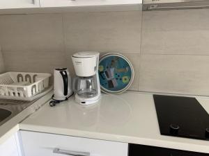 a coffee maker on a counter in a kitchen at Apartman A3 in Ulcinj