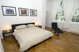 a bedroom with a bed, desk, chair and window at Galeria Rooms in Ljubljana