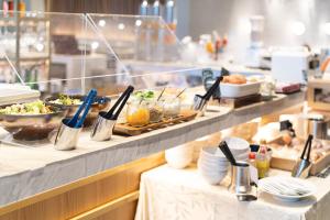 a buffet line with plates of food on display at Nikko Style Nagoya in Nagoya