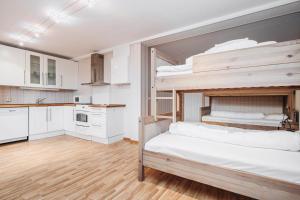 two bunk beds in a room with a kitchen at Basecamp Frich`s Hjerkinn in Hjerkinn