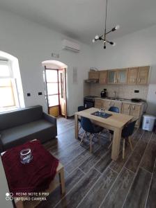 a living room with a table and a couch at Giorgina's house: Aegean view in Symi