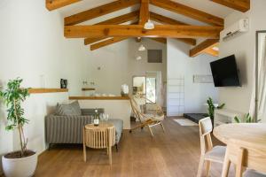 a living room with a couch and a table at Hanahala Beramot - Boutique Suites in Moshav Ramot