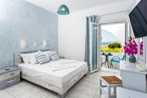 a bedroom with a bed and a view of the ocean at Villa Zeta in Chrissi Akti