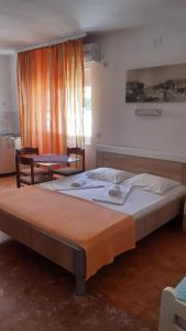 a large bed in a room with a window at Apartments Idolga in Bar