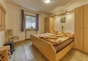 a bedroom with a large bed in a room at Erlebnishof Reiner - Urlaub auf dem Bauernhof in Sankt Englmar