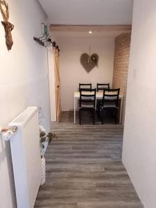 a hallway with a table with chairs and a heart on the wall at Berggasthof Schwaigerhof in Haus im Ennstal