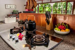 a kitchen counter with a stove and a bowl of fruit at Villa Kelapa in Lovina