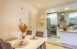 a kitchen and dining room with a table and chairs at Amazing Apartment In Los Alcázares in Los Alcázares