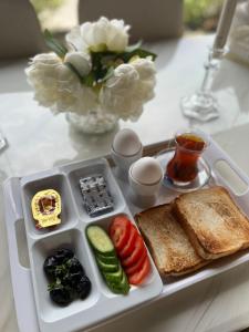 a tray of food with toast and vegetables on a table at Fakher Yanbu Hotel in Yanbu