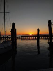 a sunset over a dock with a boat in the water at La casa di Alice in Venice