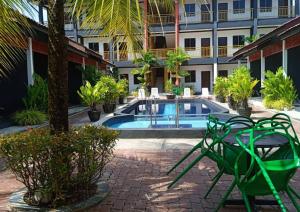 um pátio com uma piscina num edifício em Anjung Villa em Pantai Cenang