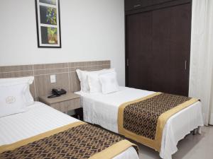 Ένα ή περισσότερα κρεβάτια σε δωμάτιο στο Hotel Cinco Monteria