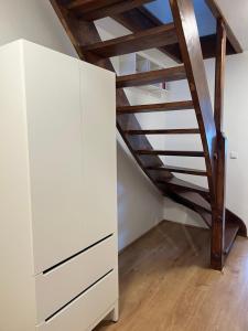 Habitación con escalera y armario blanco. en Sova, en HoÅ¡Å¥ka