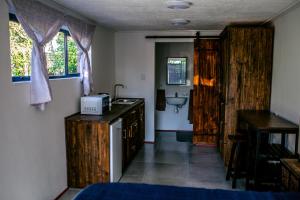 a bathroom with wooden cabinets and a sink and a sink at Peaceful 1-bedroom flatlet, 10 min from the beach in Cape Town +8 photos
