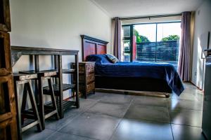 a bedroom with a bed and a window at Peaceful 1-bedroom flatlet, 10 min from the beach in Cape Town