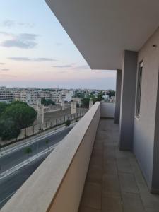a balcony with a bench and a view of a city at MYHome Lecce - SalentoSouthApulia in Lecce