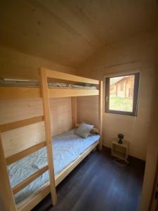 a bedroom with two bunk beds and a window at Kaszub in Borsk