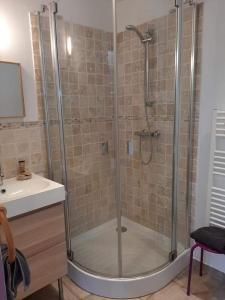 a shower with a glass door in a bathroom at lamaisonmelidine in Saint-Mards-de-Blacarville
