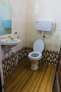 a bathroom with a toilet and a sink at Armaan Guest House in Diani Beach