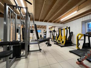 a gym with several treadmills and machines in a room at Domaine de Roullet in Roullet