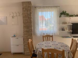 a dining room with a table and a window at Apartment Klara in Krk