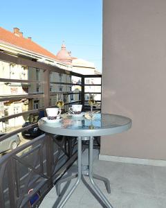 a table on a balcony with a view of a building at Stan na dan Raška in Raška
