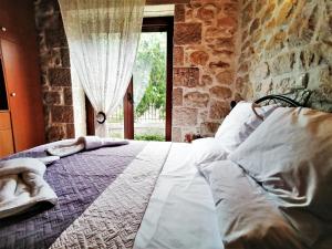 1 dormitorio con 1 cama grande y ventana en Stonehouse dome Lagadia, en Lagadia