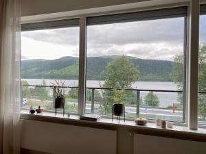a window with a view of a lake and mountains at Åre Travel - VM huset in Åre