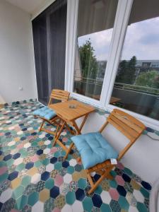 a room with two chairs and a table on a floor at Apartman Blok 45 (reka Sava) in Belgrade