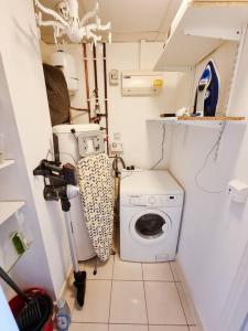 a small bathroom with a toilet and a washing machine at Luxury City Centre Home With Free Secure Parking in Stalybridge