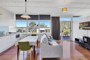 a kitchen and dining room with a table and chairs at Harmony at Tower Hill in Koroit
