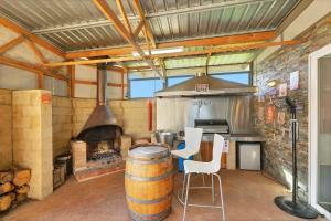 a large kitchen with a stove and a barrel at Harmony at Tower Hill in Koroit
