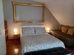 a bedroom with a bed and a couch and a mirror at Aramis House Navigli - con parcheggio Gratis - with Free parking - zona Navigli -Bocconi- Porta Genova in Milan