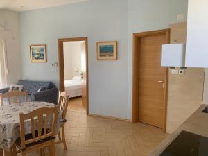 a living room with a table and a room with a bed at Apartment Klara in Krk