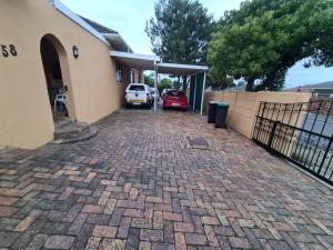 a driveway in front of a house with a car garage at Zenith House Boston Self Catering Accomodation in Cape Town