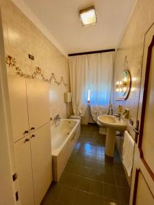 a bathroom with a sink and a tub and a toilet at Angela Home in Rimini