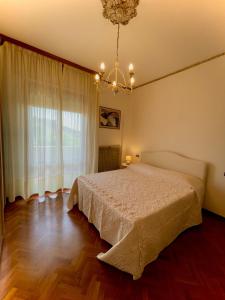 a bedroom with a bed and a large window at Angela Home in Rimini