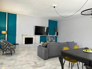 a living room with a couch and a table at Kalloni Luxury Apartment in Volos