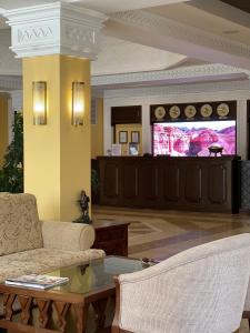 a living room with a couch and a table at Samal Resort & SPA in Almaty