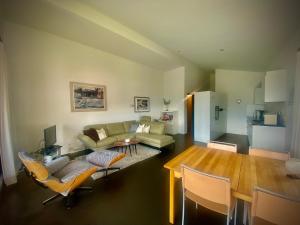 a living room with a couch and a table at Ferienwohnung Crap Ner in Flims