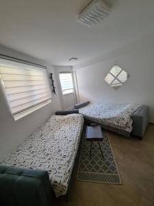 a living room with two beds and a couch at Studio MM Kopaonik in Kopaonik