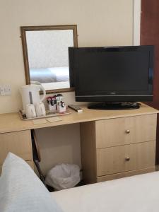 a television sitting on a desk in a bedroom at The Lumada in Blackpool