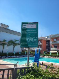 a sign in front of a swimming pool at Casa Linda Taormina Etna in Fondachello