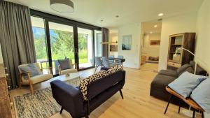 a living room with a couch and a table at Exklusive Ferienwohnung am Prielerweg in Hinterstoder in Hinterstoder