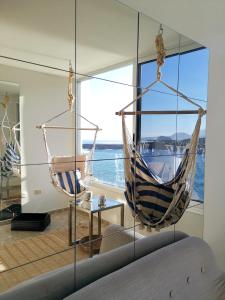 two hammocks in a room with a view of the ocean at Tenerife Stay Ocean front II in Icod de los Vinos