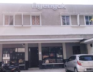 a white car parked in front of a building at Nyenyak Senayan Benhil in Jakarta