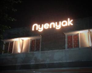 a neon sign on the side of a building at Nyenyak Senayan Benhil in Jakarta