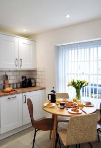 a kitchen with a table with food on it at The Old Captains Lookout in Falmouth